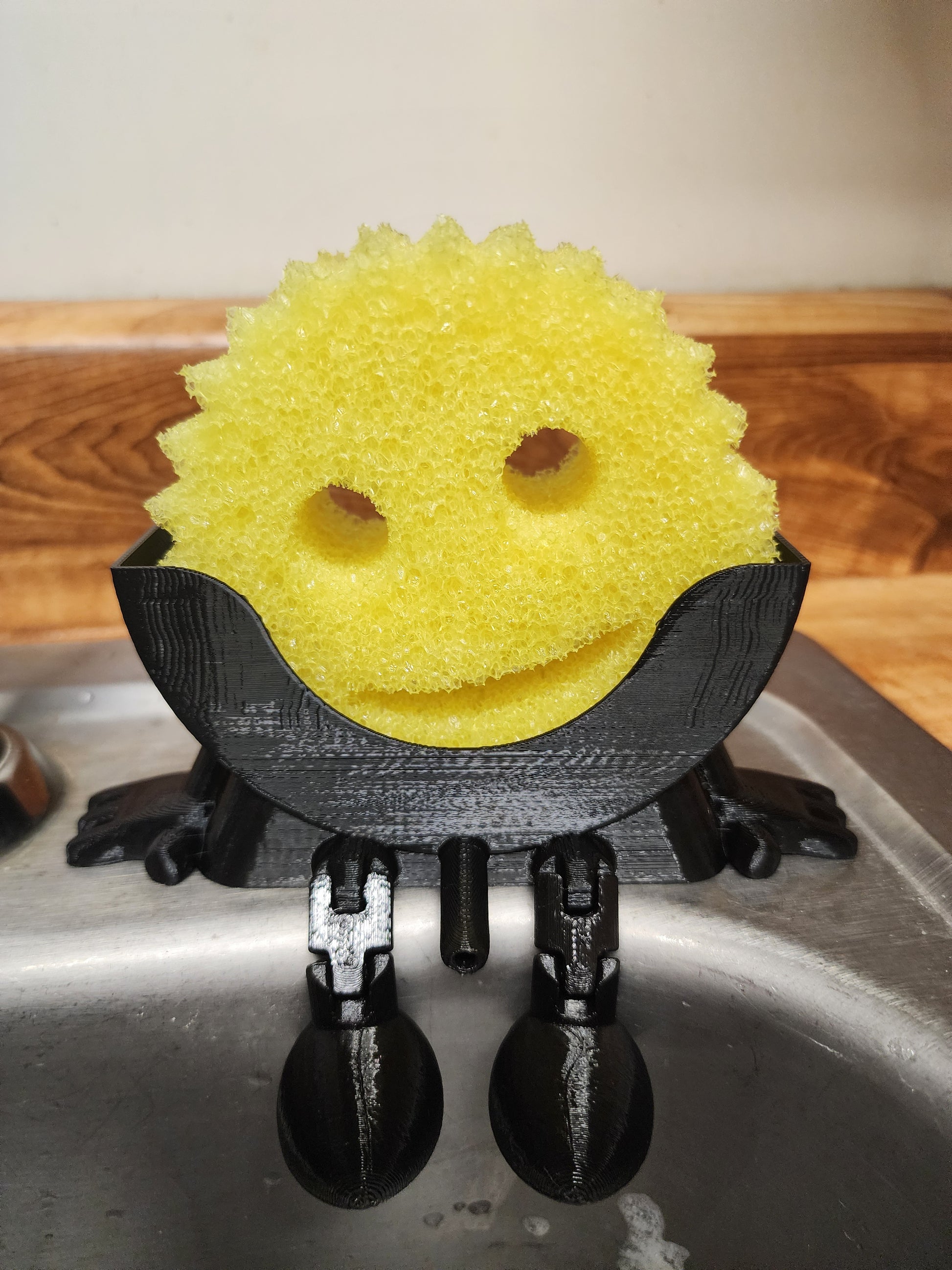 Keep your sink neat, your sponge dry, and your kitchen stylish with Mr. Dripper! A clever 3D Printed holder, designed for everyday convenience.

Made with a drip-dry design, Mr. Dripper allows proper airflow, so your sponge dries faster, helping reduce odors and mess around the sink. Its compact size fits easily by the faucet without taking up valuable counter space.