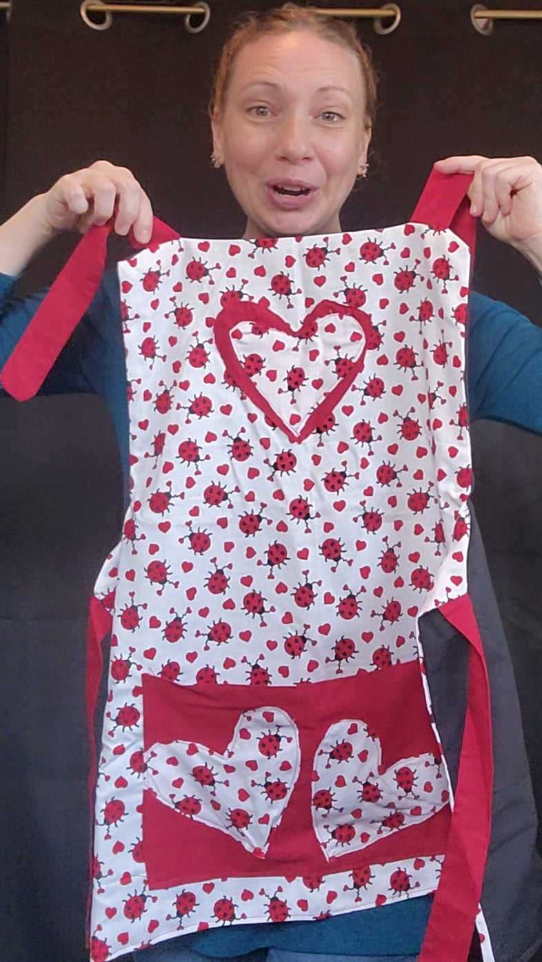 Make Valentine’s Day extra sweet with our Love Bug Child Apron, thoughtfully handmade to match our coordinating adult apron for the perfect parent-and-child kitchen duo. Featuring an all-over ladybug and heart print with charming red accents, this apron is designed to bring fun, love, and creativity into every little helper’s cooking or crafting adventure.