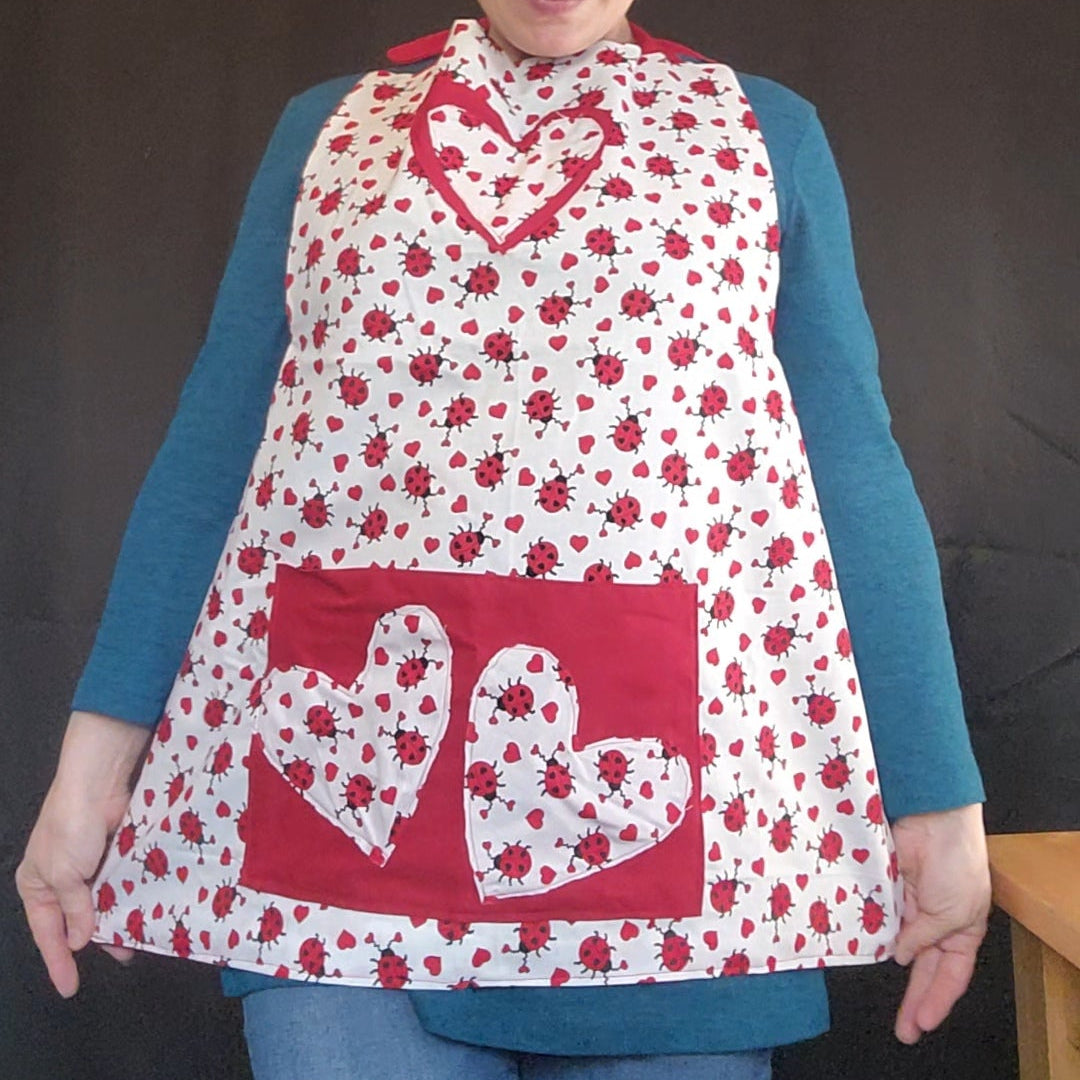Make Valentine’s Day extra sweet with our Love Bug Child Apron, thoughtfully handmade to match our coordinating adult apron for the perfect parent-and-child kitchen duo. Featuring an all-over ladybug and heart print with charming red accents, this apron is designed to bring fun, love, and creativity into every little helper’s cooking or crafting adventure.