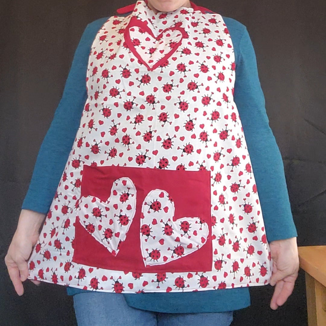 Make Valentine’s Day extra sweet with our Love Bug Child Apron, thoughtfully handmade to match our coordinating adult apron for the perfect parent-and-child kitchen duo. Featuring an all-over ladybug and heart print with charming red accents, this apron is designed to bring fun, love, and creativity into every little helper’s cooking or crafting adventure.