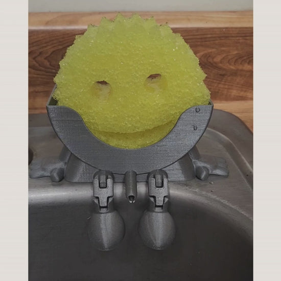 Meet Mr. Dripper, the tidy little helper your sink has been waiting for. Designed specifically to hold your Scrub Daddy, this clever sponge holder keeps your sponge upright, dry, and always within reach.

No more soggy sponges or cluttered sink edges, Mr. Dripper allows proper airflow so your Scrub Daddy dries faster and stays fresher between uses. Its compact, sink-friendly design fits perfectly near the faucet, making daily cleanup easier and more organized.