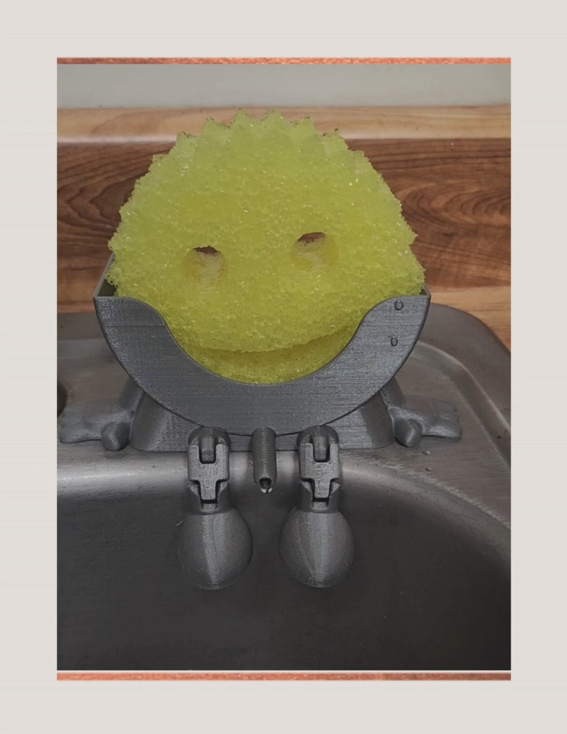 Meet Mr. Dripper, the tidy little helper your sink has been waiting for. Designed specifically to hold your Scrub Daddy, this clever sponge holder keeps your sponge upright, dry, and always within reach.

No more soggy sponges or cluttered sink edges, Mr. Dripper allows proper airflow so your Scrub Daddy dries faster and stays fresher between uses. Its compact, sink-friendly design fits perfectly near the faucet, making daily cleanup easier and more organized.