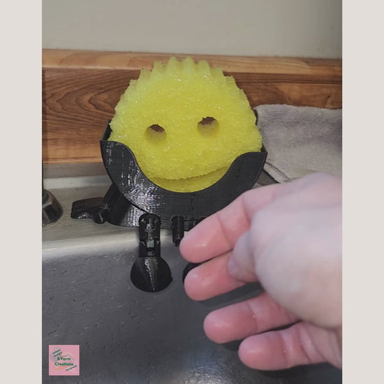 Keep your sink neat, your sponge dry, and your kitchen stylish with Mr. Dripper! A clever 3D Printed holder, designed for everyday convenience.

Made with a drip-dry design, Mr. Dripper allows proper airflow, so your sponge dries faster, helping reduce odors and mess around the sink. Its compact size fits easily by the faucet without taking up valuable counter space.